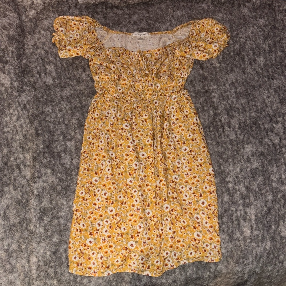 A yellow with flower dress, size medium, from passport, size medium.